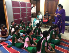 A Teacher Teaching to Girl Students in a Classroom